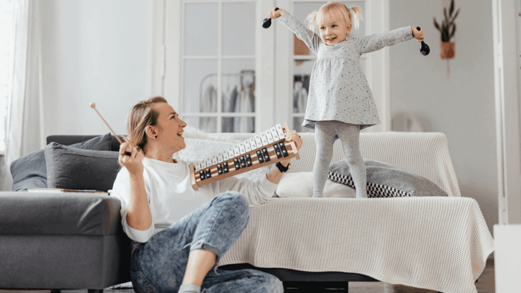 Woman and young girl playing with musical instruments
